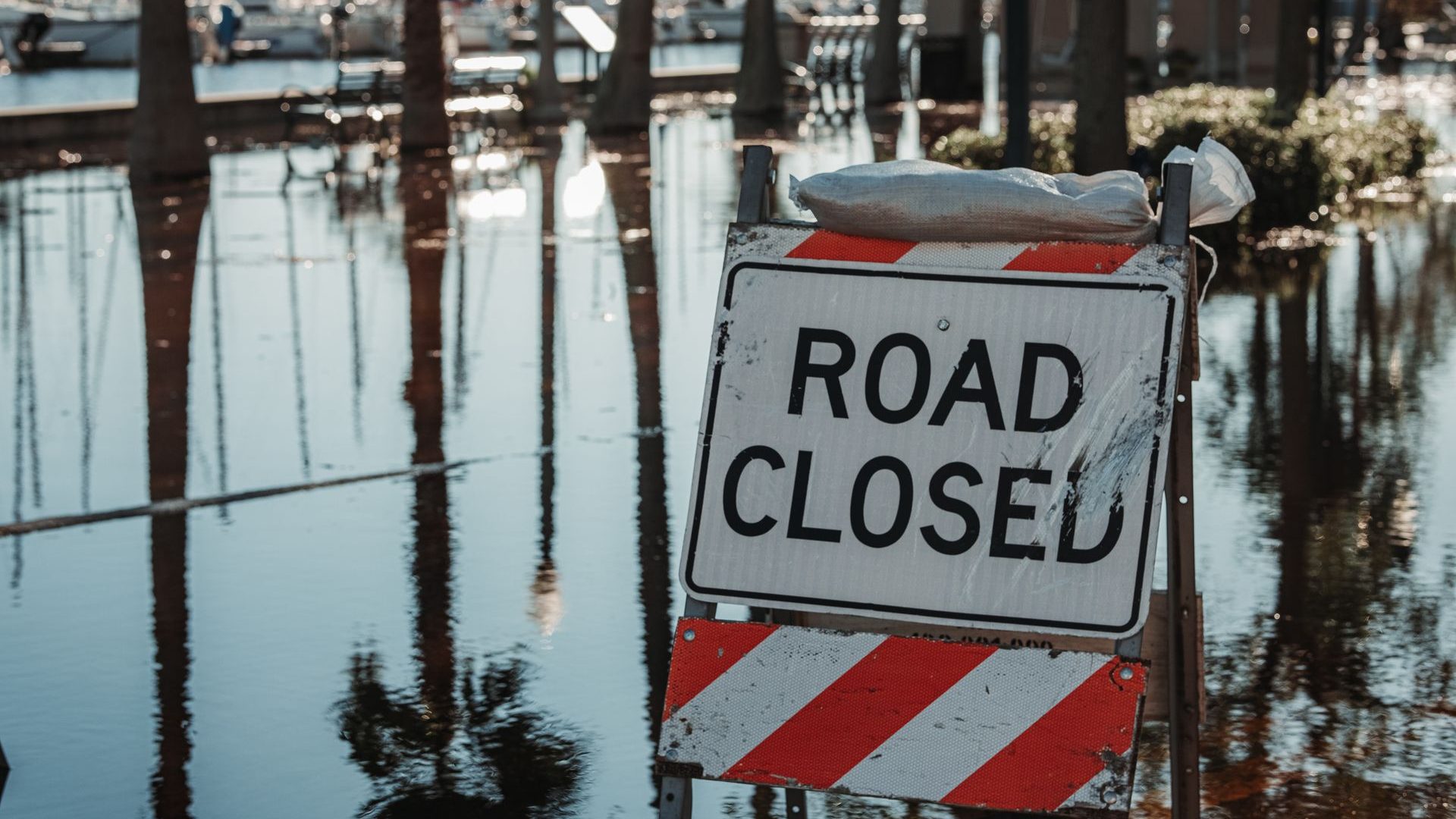 Road closed sign on a flooded street in Florida after a storm